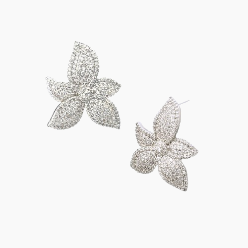 Butterfly-shaped earrings with sparkling details on a light gray background