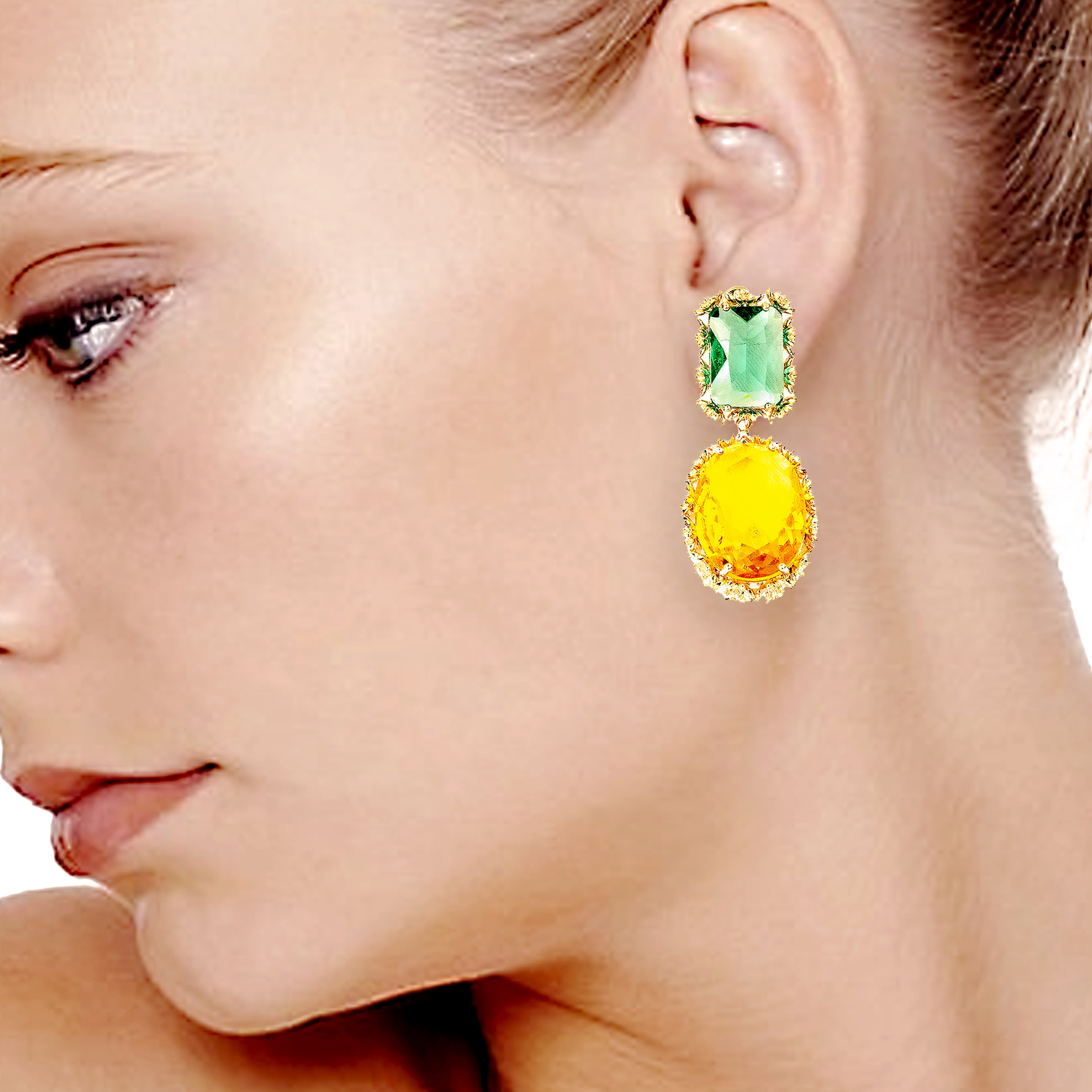 Close-up of a woman wearing colorful gemstone earrings.