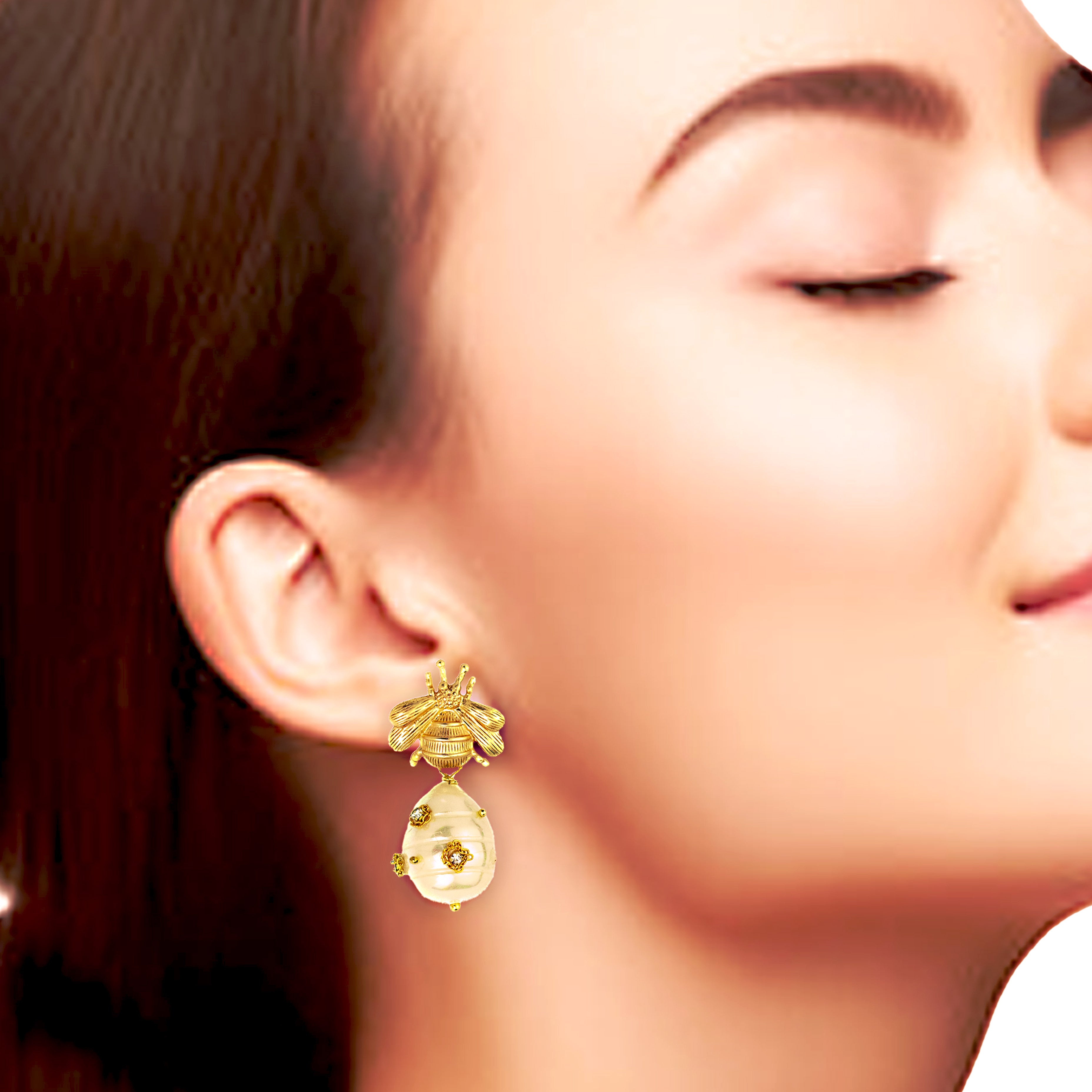 Close-up of a woman wearing gold earrings with a blurred background