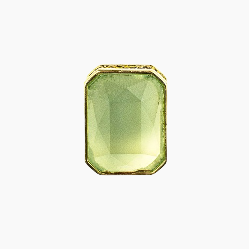 Green gemstone with gold setting on a white background