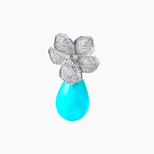 Jewelry with floral design and turquoise stone on a white background
