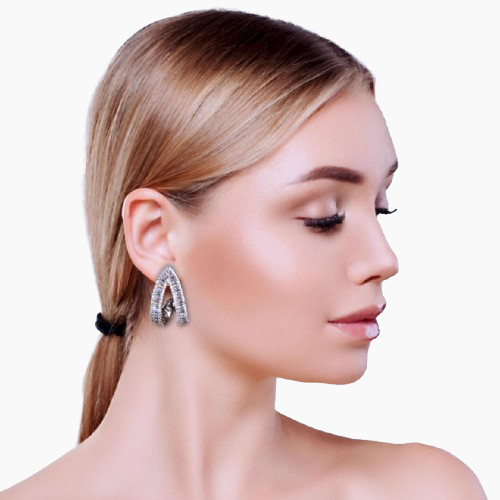 Woman wearing a silver earring with a white background