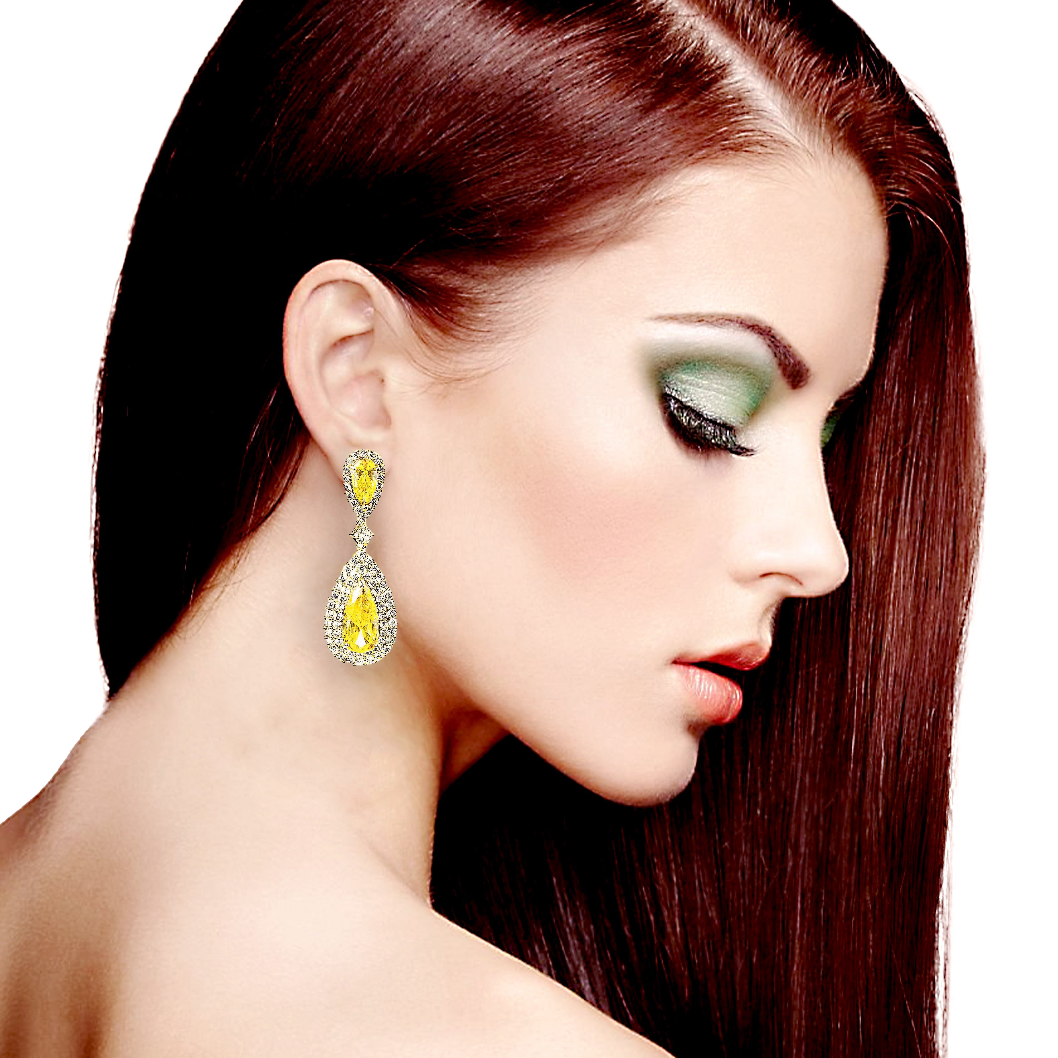 Woman wearing a yellow teardrop earring with a white background