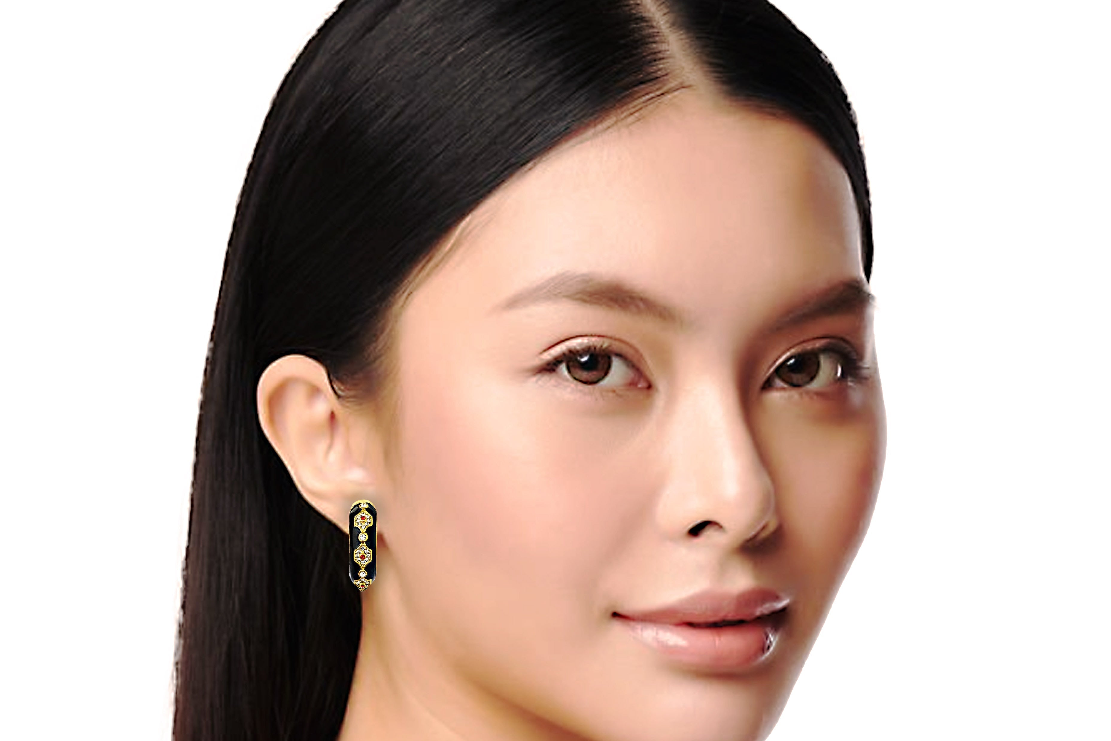 Close-up of a woman wearing earrings with a plain background