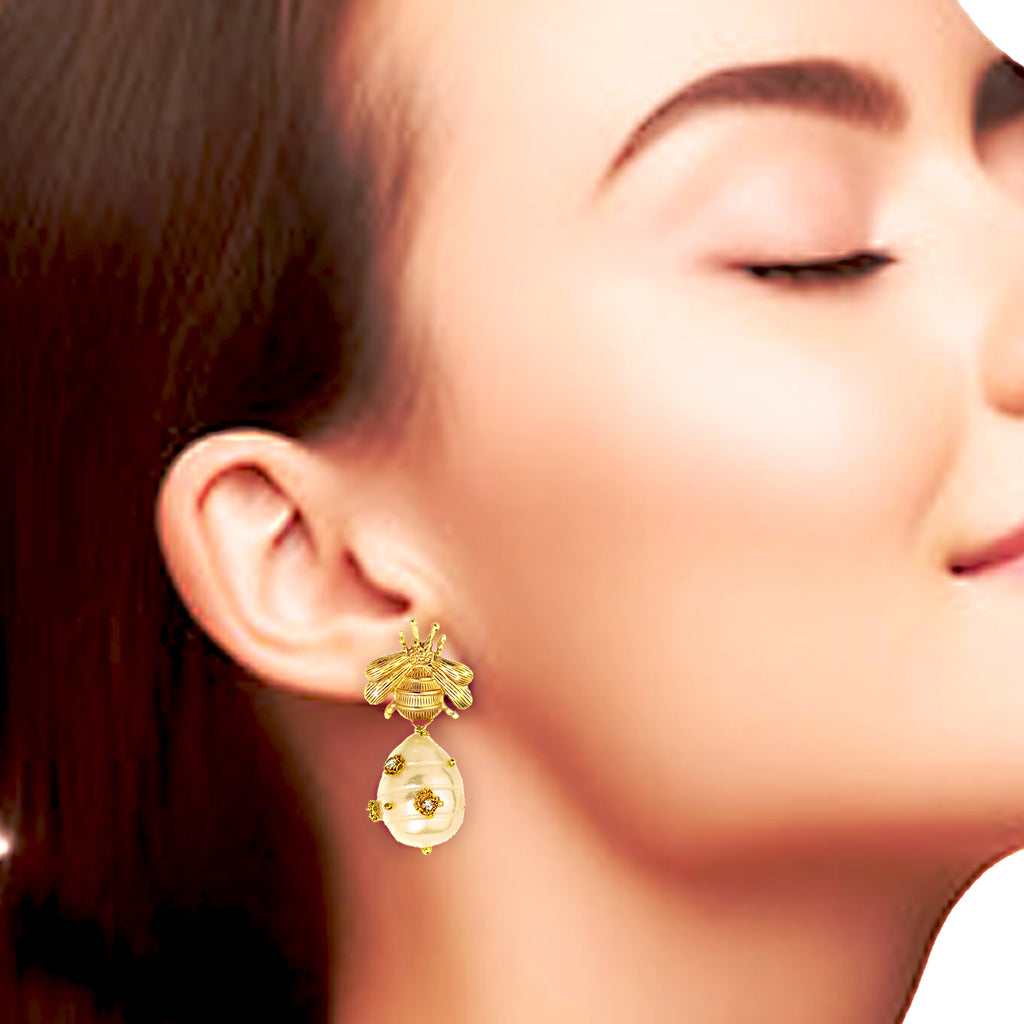 Close-up of a woman wearing gold earrings with a blurred background