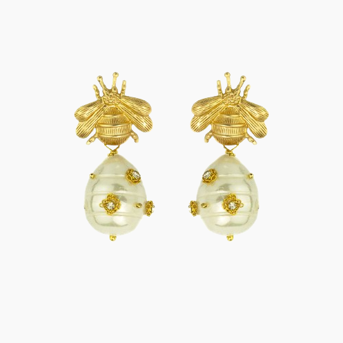 Gold bee earrings with pearl-like droplets on a white background