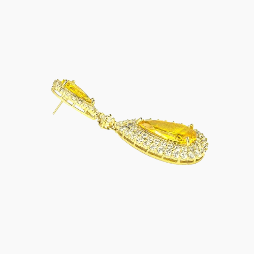 Gold earring with yellow gemstone on a white background