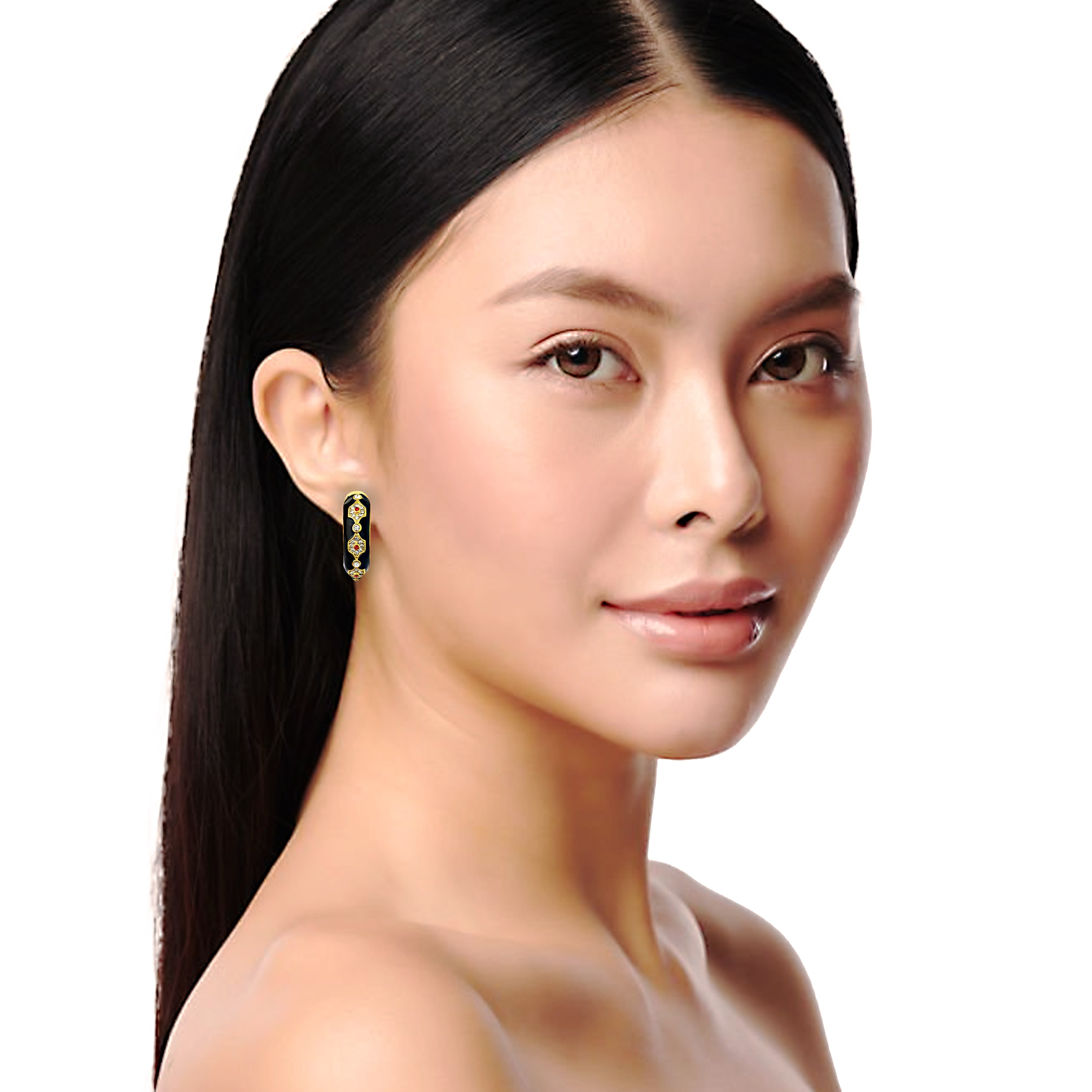 Woman wearing a gold earring on a white background