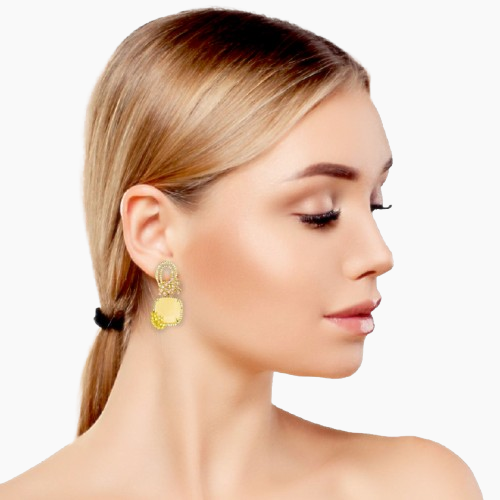 Woman wearing a gold earring with a white background