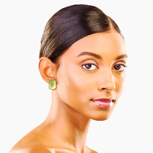 Woman wearing a green earring on a white background