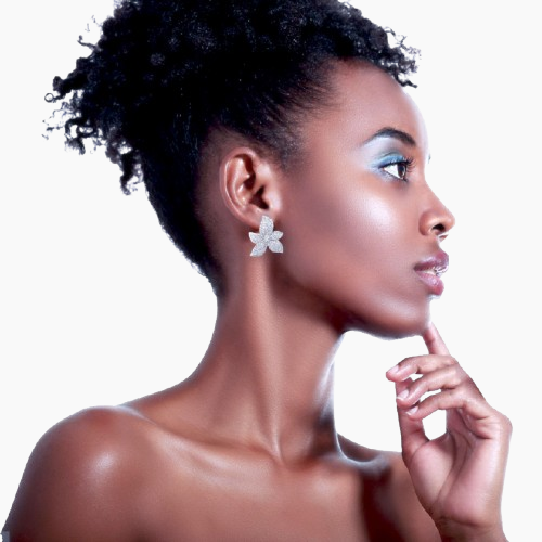 Woman wearing a star-shaped earring against a neutral background