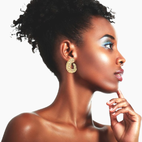 Woman wearing gold hoop earrings with a neutral background