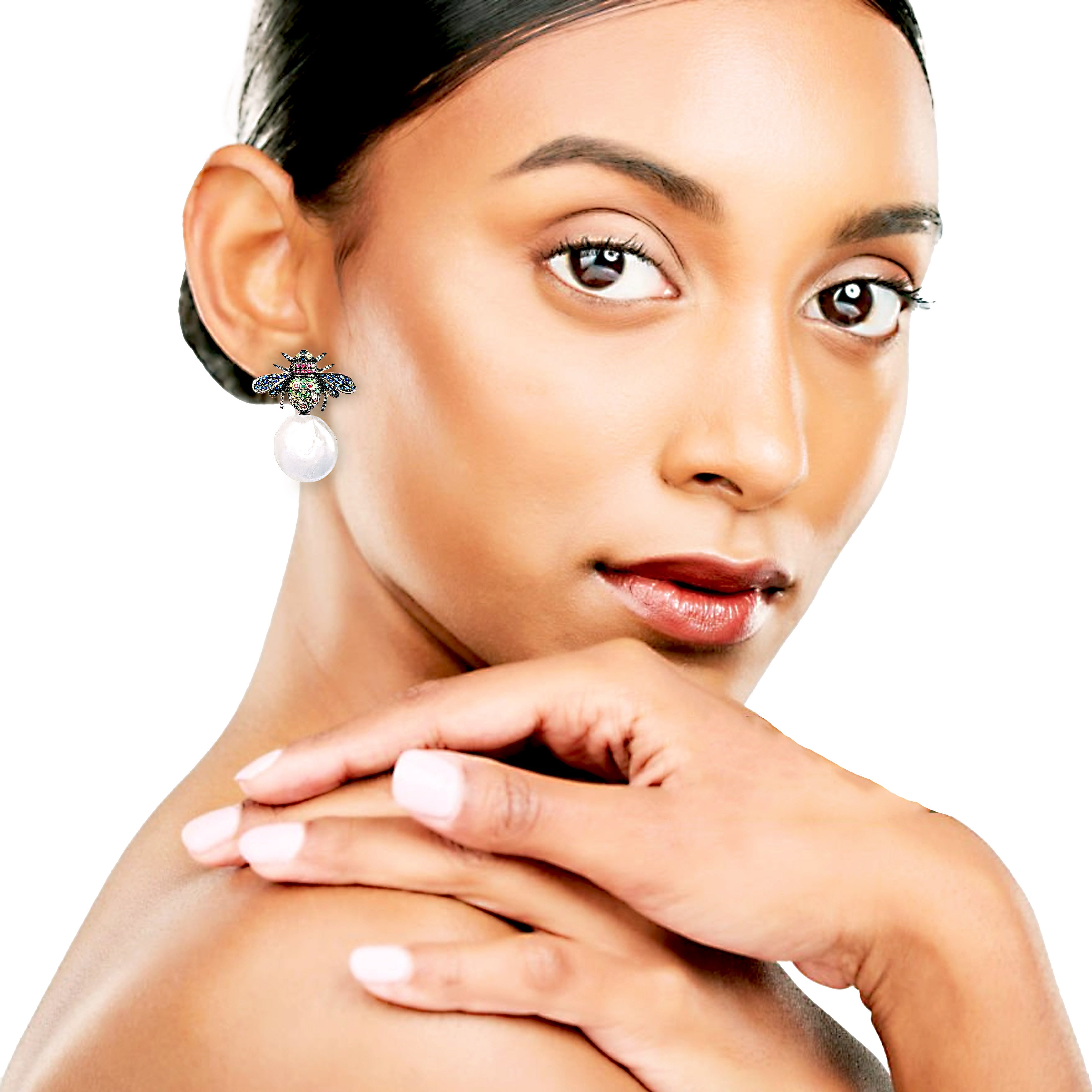 Woman wearing pearl earrings with a neutral background